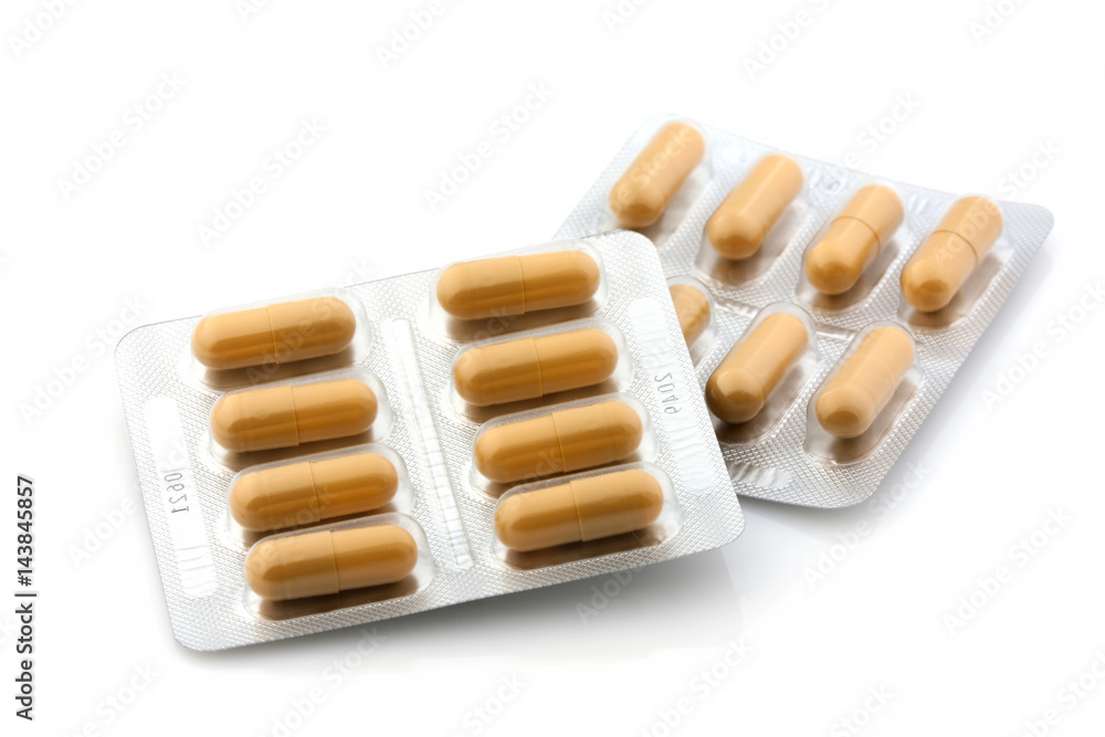 Packing of yellow tablets on a white background. Isolated Packing of yellow tablets on a white background. Isolated