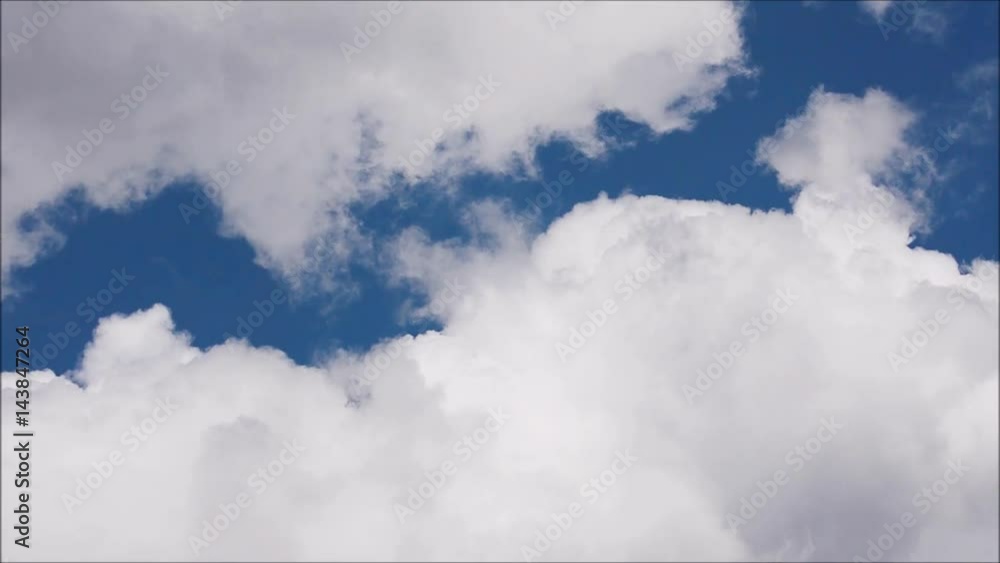 White clouds move across clear blue sky. Cloudy blue sky background. White clouds move across clear blue sky. Cloudy blue sky background.