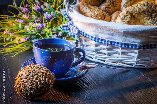 A cup of tea with soft rolls.