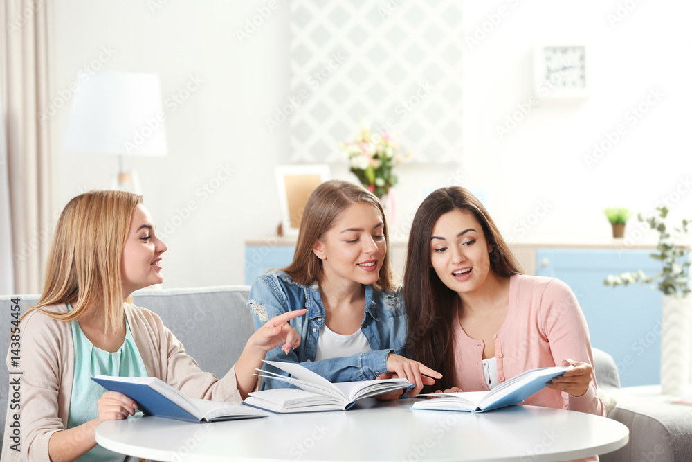 Women sitting at table in book club Women sitting at table in book club