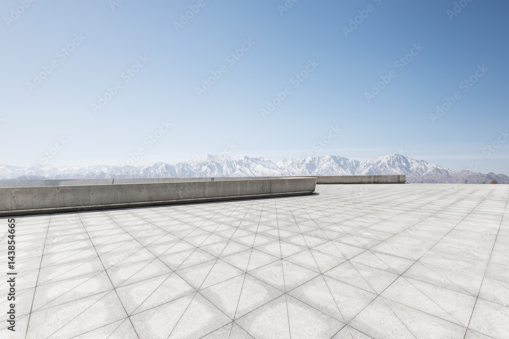 Obraz premium empty brick floor with white snow mountains