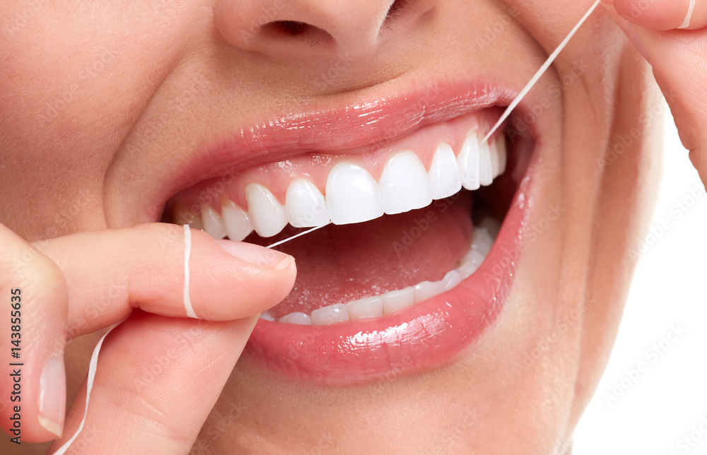Fototapeta premium woman smile with tooth floss