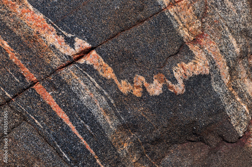 Cracks and veins in a gneiss rock photo