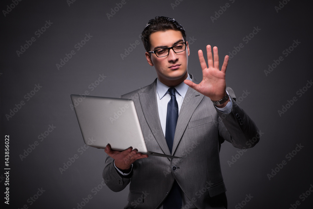 Handsome businessman working on laptop computer