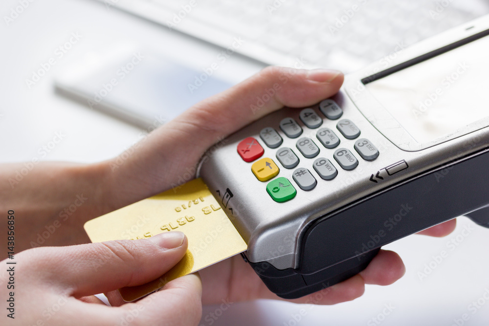 Online payment concept with credit card and terminal on white background Online payment concept with credit card and terminal on white background