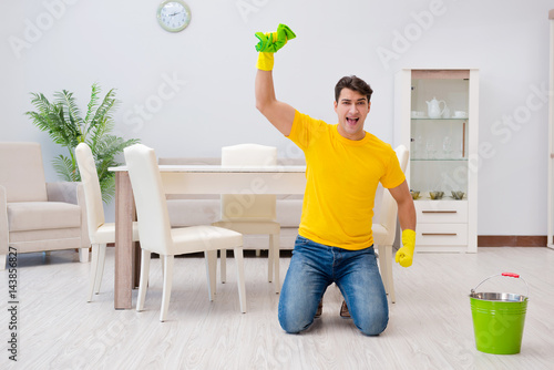 Man cleaning the house helping his wife