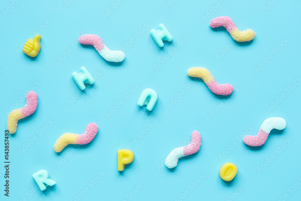 sweets and sugar candies on blue background top view pattern sweets and sugar candies on blue background top view pattern