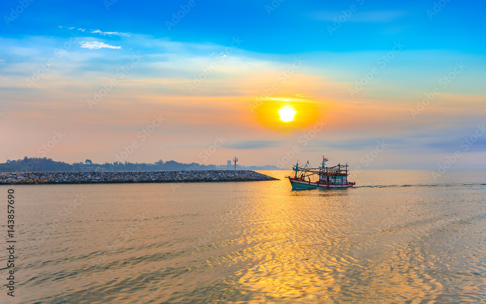 calmness seashore with fishing boat over the sea in beautiful morning sunrise