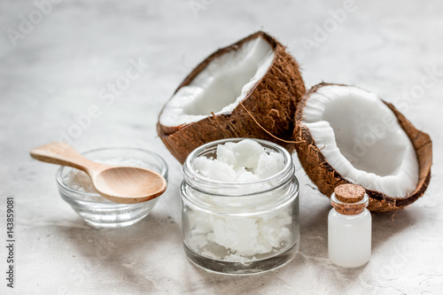 fresh coconut with cosmetic oil in jar on white background
