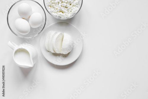 Fresh dairy products on white table background top view mockup