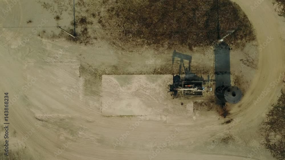 Aerial view from a drone of oil pumpjack (sucker rod beam) in the field on sunny day
Aerial view from a drone of oil pumpjack (sucker rod beam) in the field on sunny day
