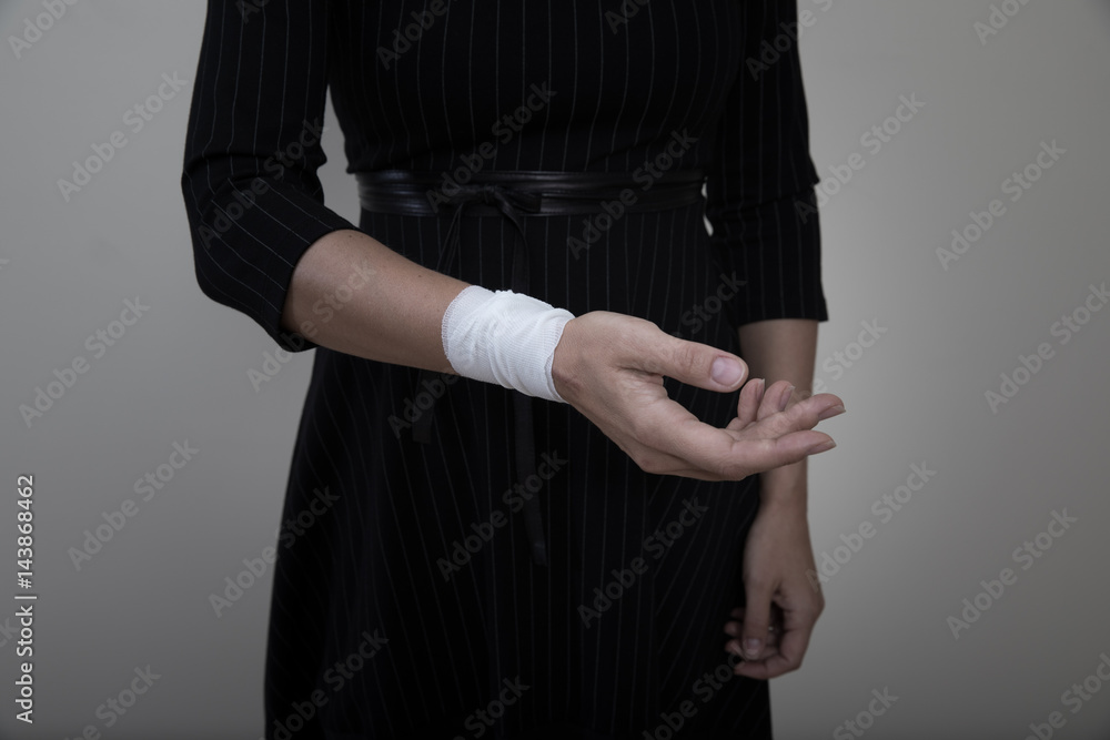 Middle age woman showing her bandaged wrist.