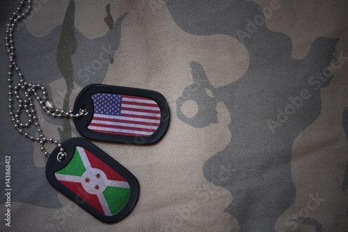 Foto army blank, dog tag with flag of united states of america and burundi on the khaki texture background
