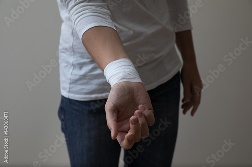 Middle age woman showing her bandaged wrist.