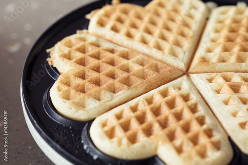 Freshly backed waffles in shape of heart, close up
