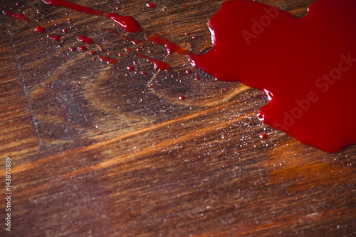 A puddle of blood on a wooden background