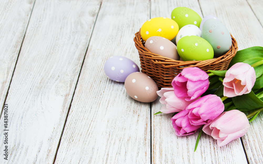 Basket with easter eggs and tulips Basket with easter eggs and tulips