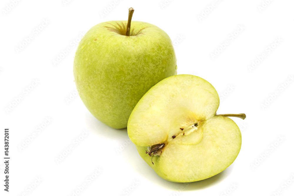 One whole and sliced green apple in droplets of dew isolated on white background One whole and sliced green apple in droplets of dew isolated on white background