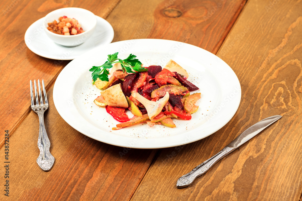 Plate of salad on a wooden table Plate of salad on a wooden table