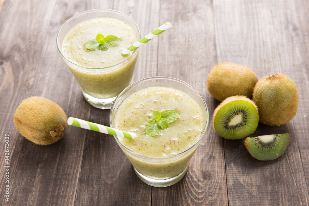 kiwi smoothie with fresh fruits on wooden background. Top view kiwi smoothie with fresh fruits on wooden background. Top view