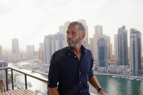 Man standing at balcony. photo