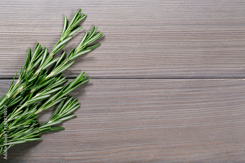 Organic bunch of fresh rosemary on the old grey wooden background. Free space for your text Organic bunch of fresh rosemary on the old grey wooden background. Free space for your text