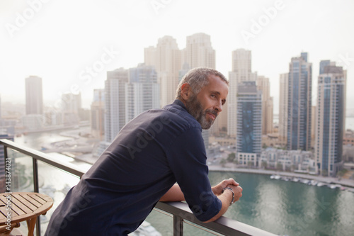 Man leaning at balcony.