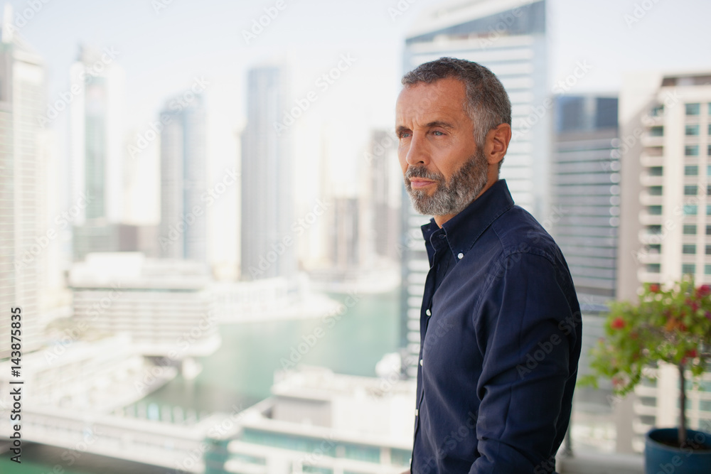 © phocal Media - Expat man standing outdoors.