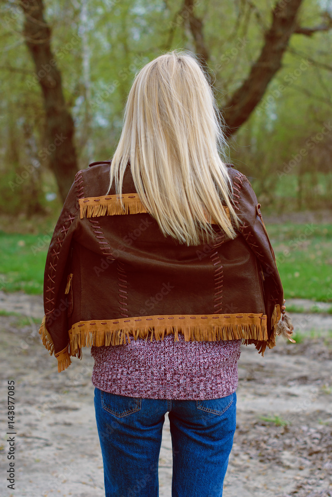 Young sexy stylish blonde girl in nature near a river and trees in American country style in a leather jacket, sweater blue jeans and brown boots with a beautiful face and pretty eyes
Young sexy stylish blonde girl in nature near a river and trees in American country style in a leather jacket, sweater blue jeans and brown boots with a beautiful face and pretty eyes