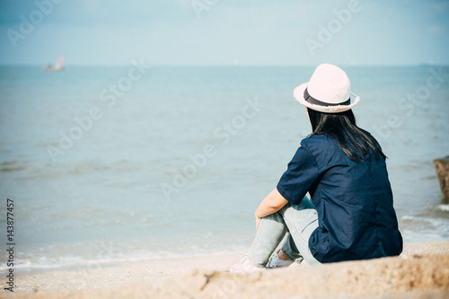 woman sitting on the beach , summer and holiday concept