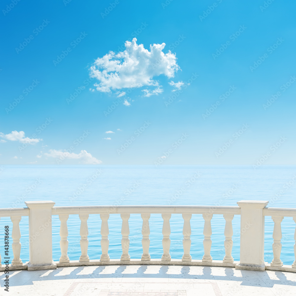 white balcony near sea and blue sky with cloud over it