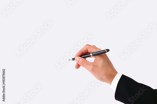 Close-up of hand writing with a pen isolated with clipping mask.

