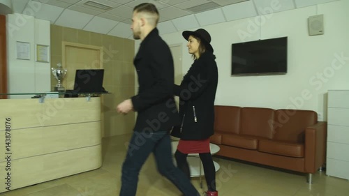 a young couple exits the hotel through the reception photo