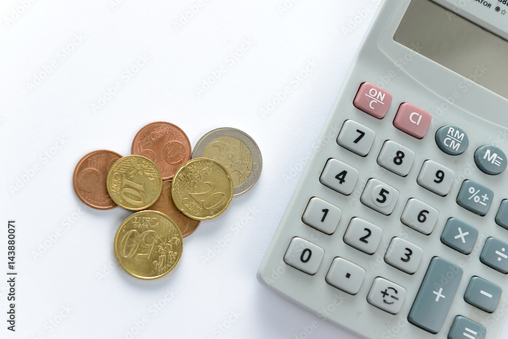 Euro money coins counting with calculator on white background Euro money coins counting with calculator on white background