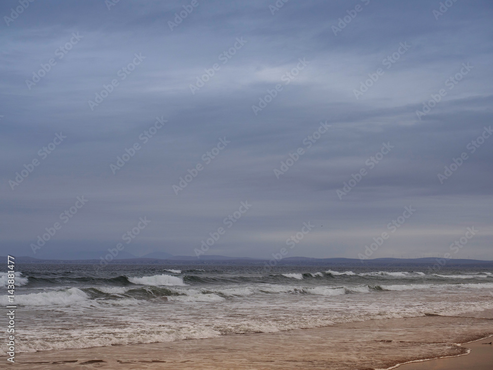 Wave rushing onto a beach. Wave rushing onto a beach.