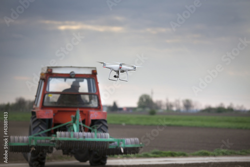 Drone flying in front of tractor