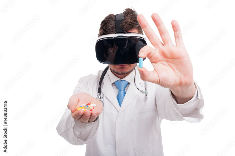 Young medic showing one pill from his hand Young medic showing one pill from his hand