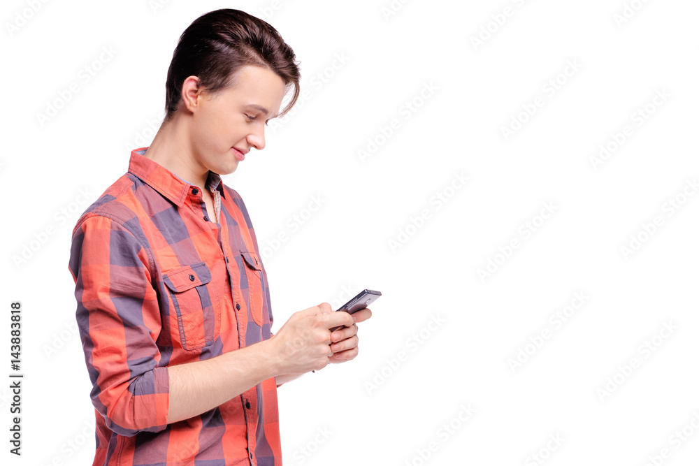 Youth and technology. Studio portrait of handsome young man using smart phone. Isolated on white. Youth and technology. Studio portrait of handsome young man using smart phone. Isolated on white.