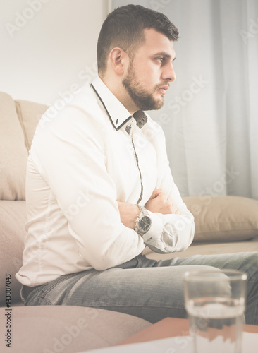 Sad young man spending day alone