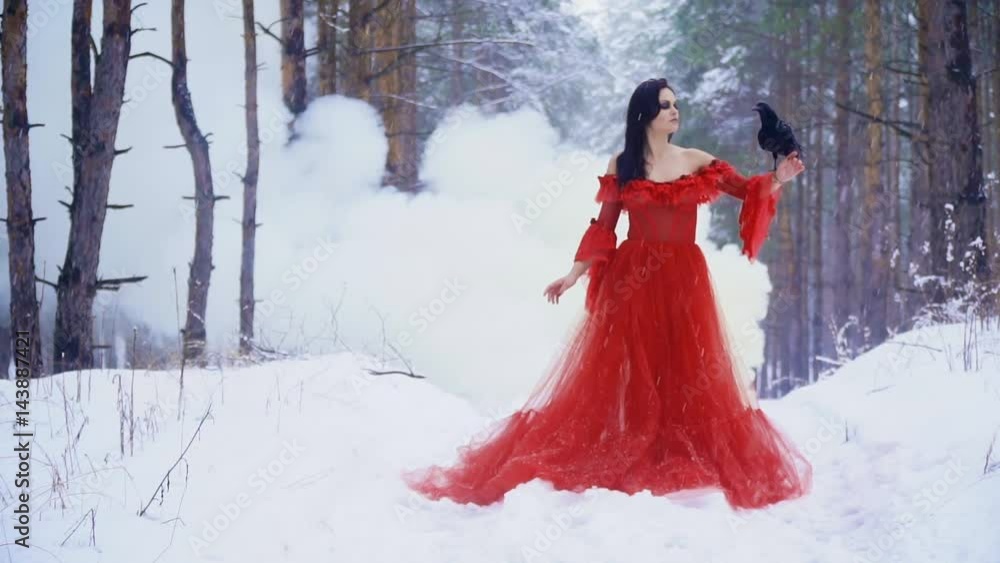 A girl in a long red dress is worth noticing smoke behind A girl in a long red dress is worth noticing smoke behind