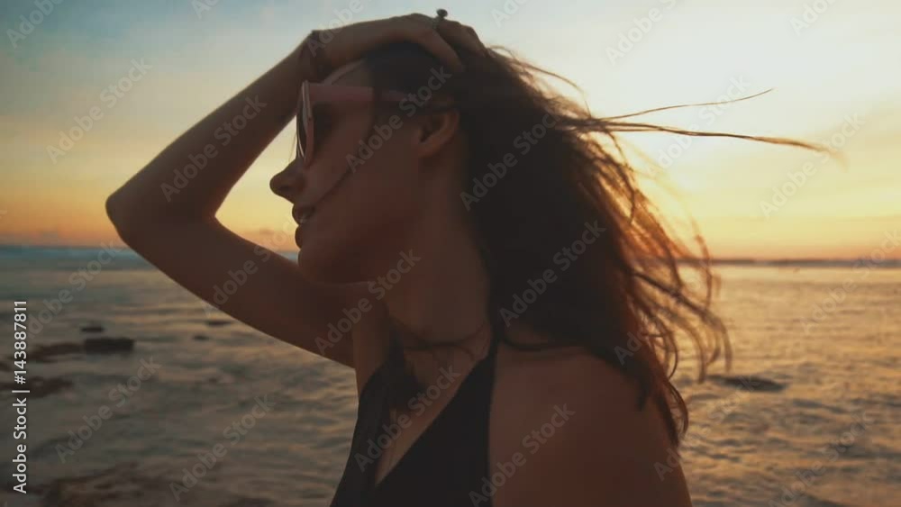 Close up portrait of beautiful young woman smiling on tropical beach at sunset Close up portrait of beautiful young woman smiling on tropical beach at sunset