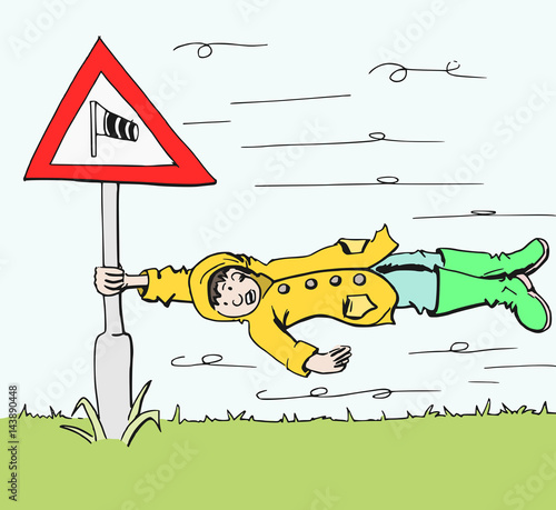 Jongen met regenjas waait bijna weg