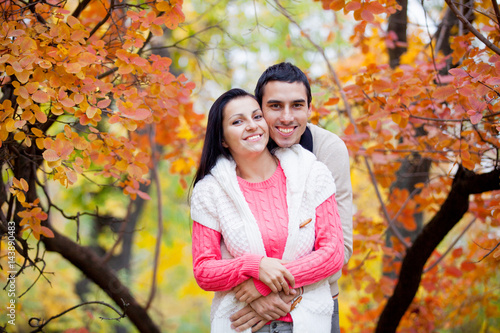 photo of cute couple hugging on the wonderful yellow trees background