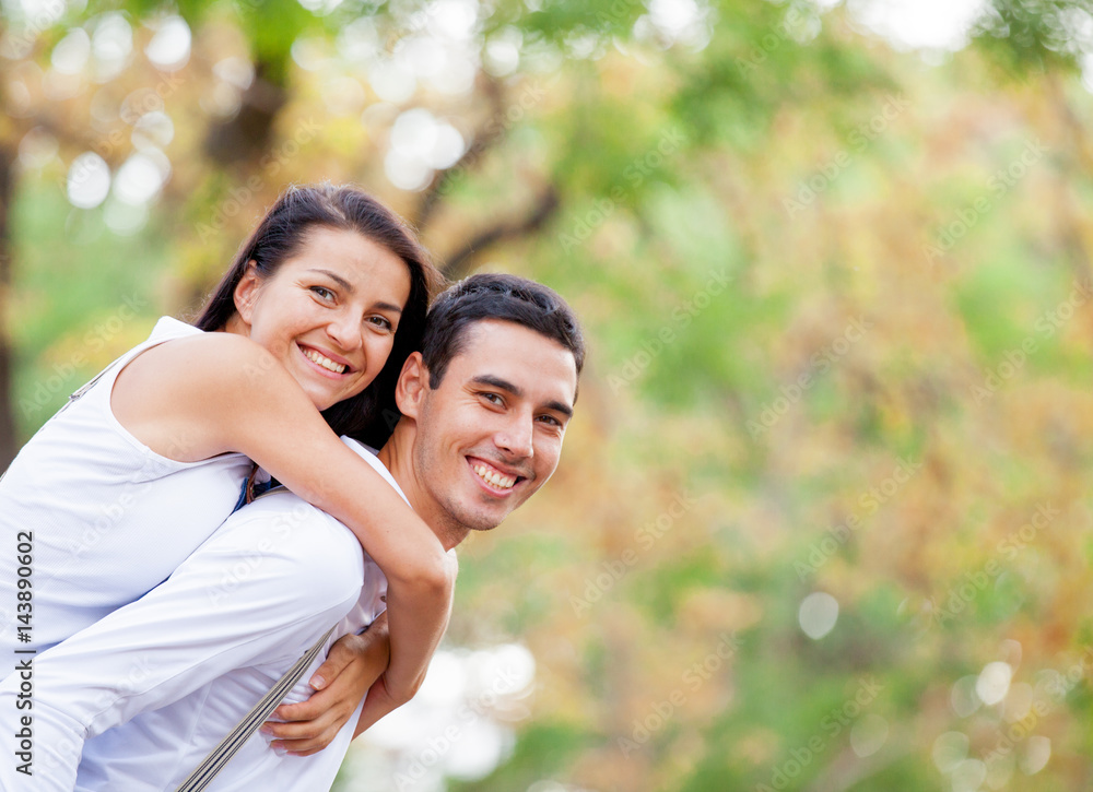 photo of cute couple hugging on the wonderful autumn park background photo of cute couple hugging on the wonderful autumn park background