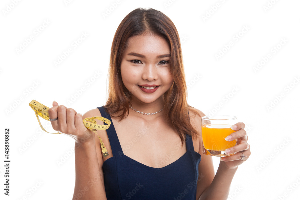 Asian woman drink orange juice hold measuring tape. Asian woman drink orange juice hold measuring tape.