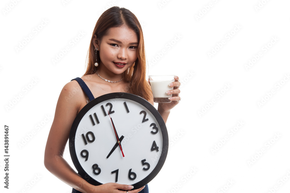 Healthy Asian woman drinking glass of milk hold clock. Healthy Asian woman drinking glass of milk hold clock.