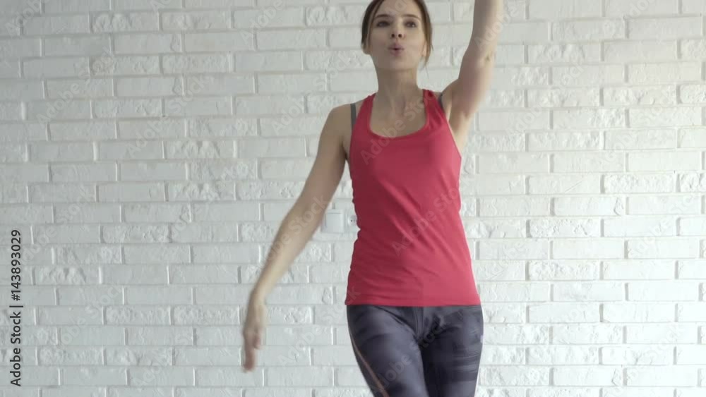 Young woman exercising, kicking legs at home
Young woman exercising, kicking legs at home