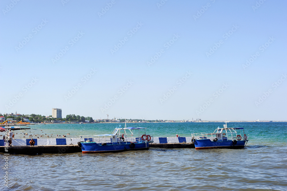 Two fishing boat are waiting for tourists on the pier