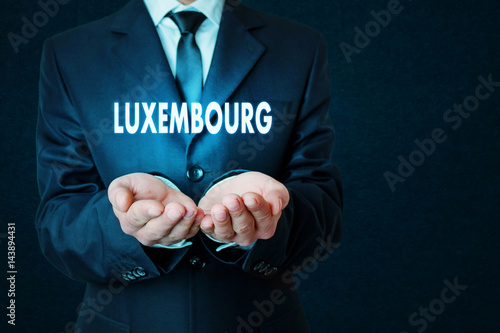 Businessman holding Luxembourg word