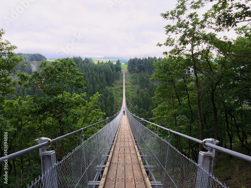 Geierlay suspension bridge from south to north with a man taking pictures photo